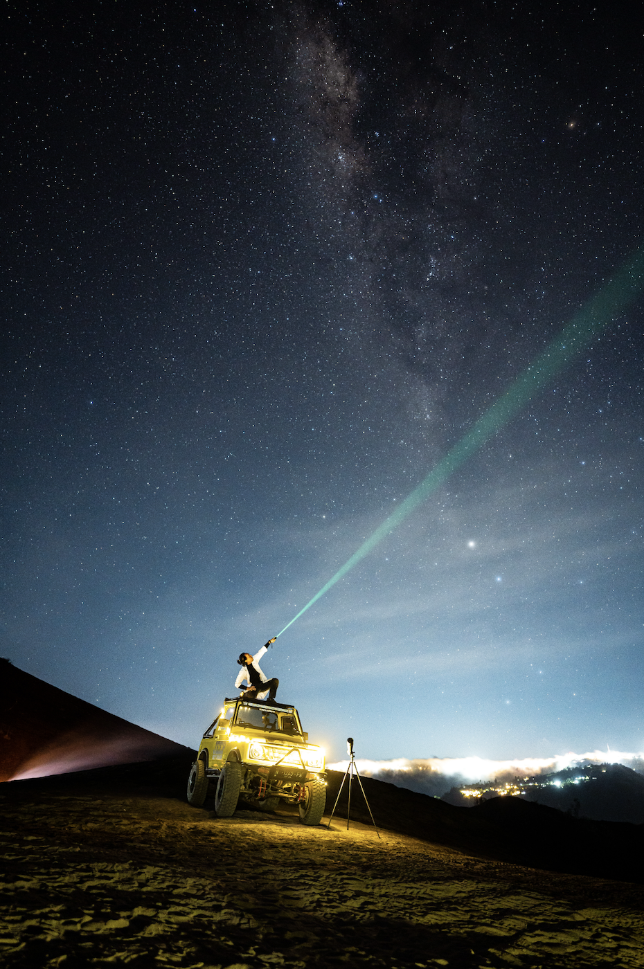 4x4 jeep on the volcanic ridge of Mount Batur under a starry sky